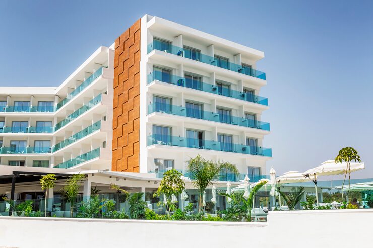 Hotel property photo showing exterior-hotel-resort-with-swimming-pool-sun-loungers_120897-1800